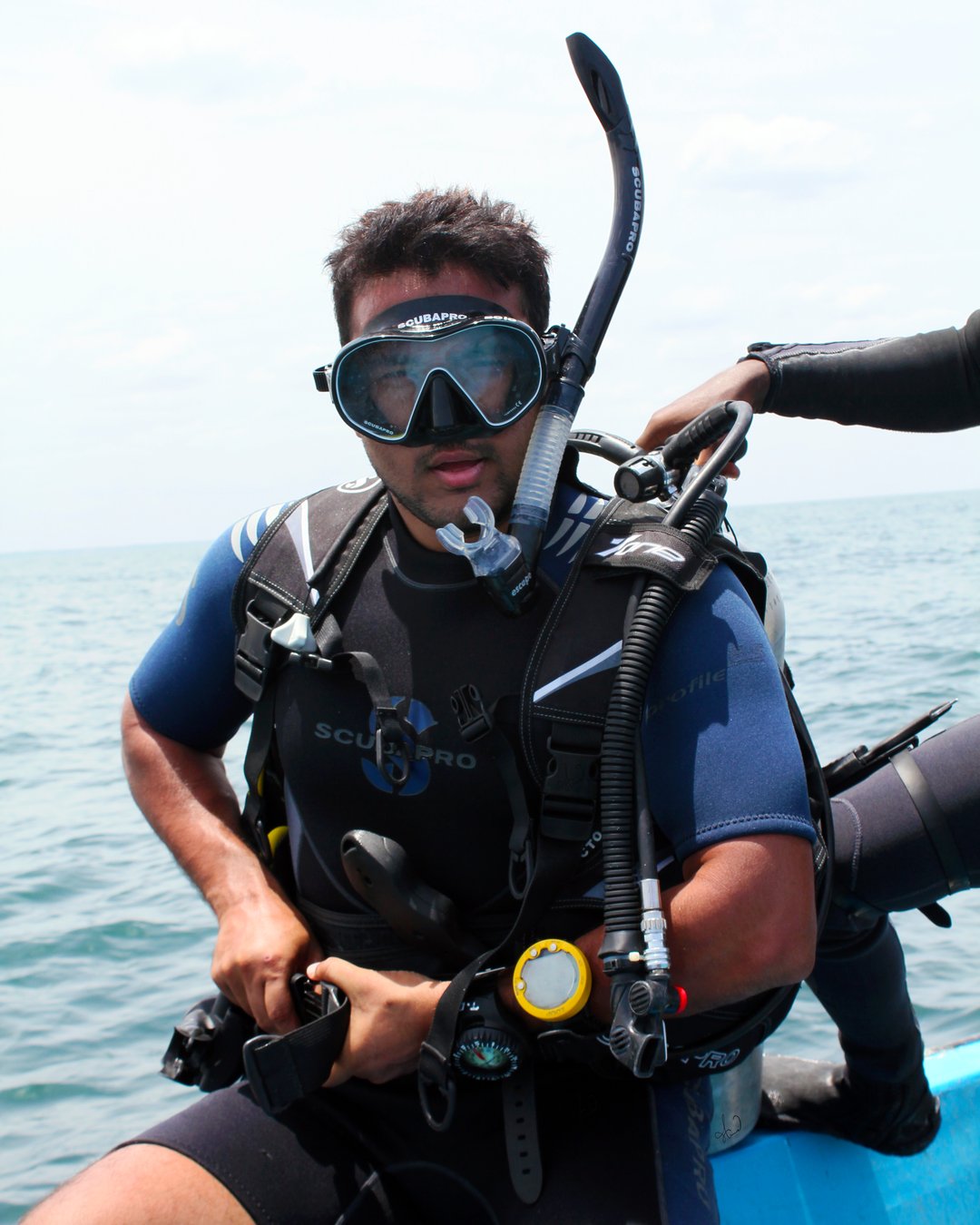 A scuba diver kitted up and ready to dive